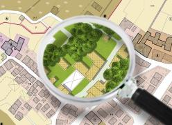 Urban plan with buildings, roads and a magnifying glass
