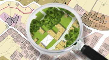 Urban plan with buildings, roads and a magnifying glass